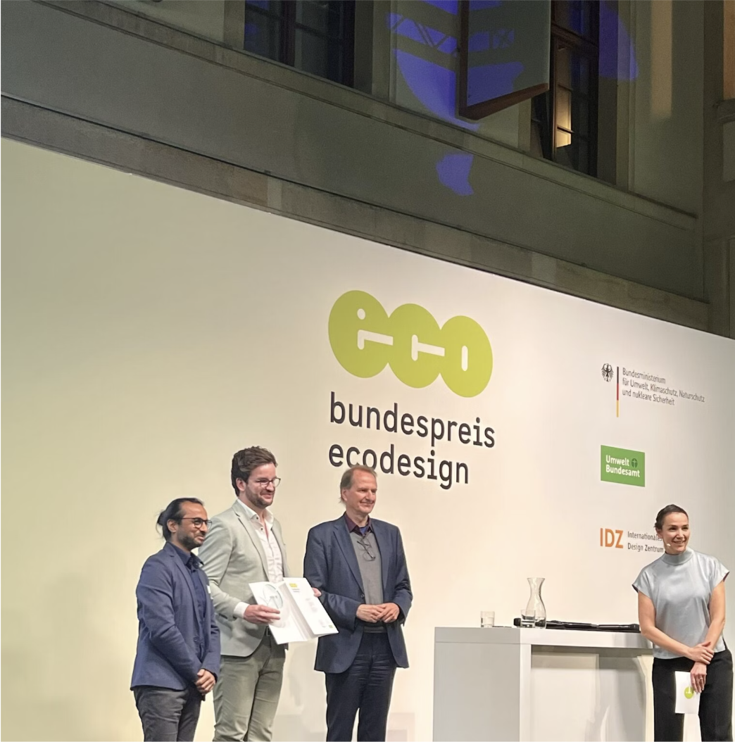 FixFirst team receiving the Bundespreis Ecodesign award on stage