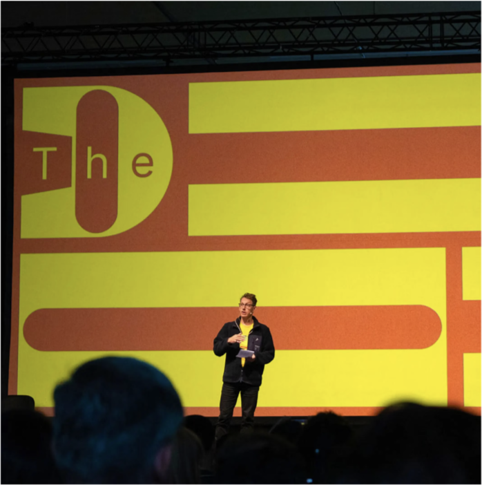FixFirst founder speaking on stage at TheDrop50
